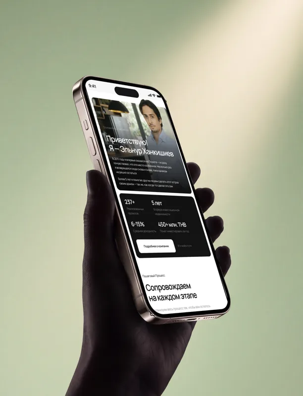 Property Library mobile page on a phone held in a hand against a sage background